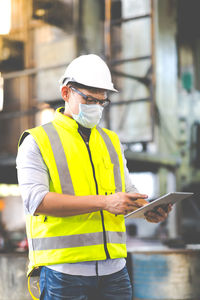 Midsection of man working with mobile phone