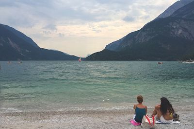 People on beach against sky