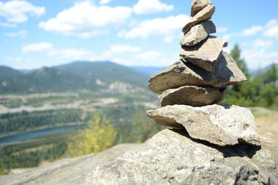 Stack of rocks on mountain against sky