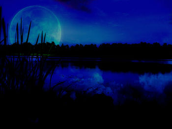 Scenic view of lake against sky at night