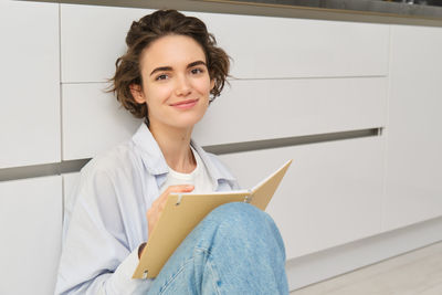 Portrait of young woman using mobile phone