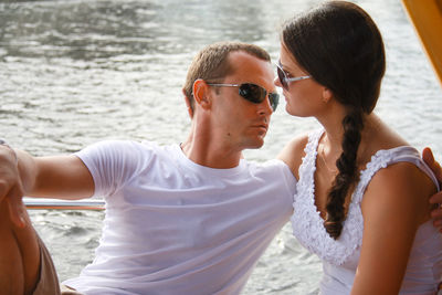 Young couple romancing against lake