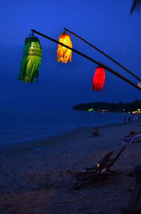 People at beach against sky