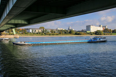 Scenic view of river against sky in city