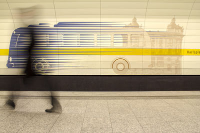 Blurred motion of person walking at subway station