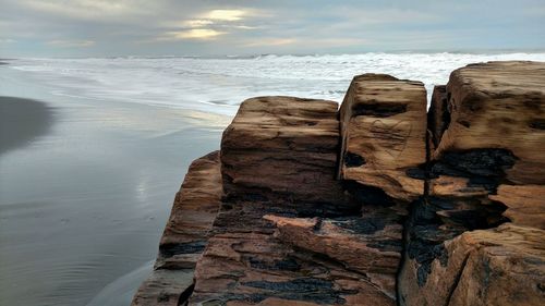 Close-up of beach against sky