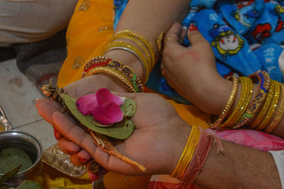 Midsection of woman holding flowers