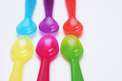 Close-up of colored pencils over white background