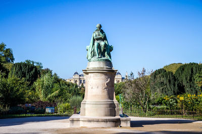 Statue against clear blue sky