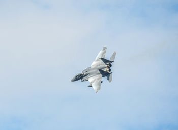 Low angle view of bird flying against clear sky