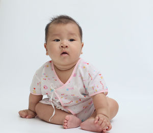 Portrait of cute baby against white background