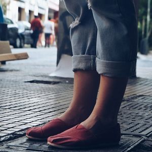 Low section of woman standing on tiled floor