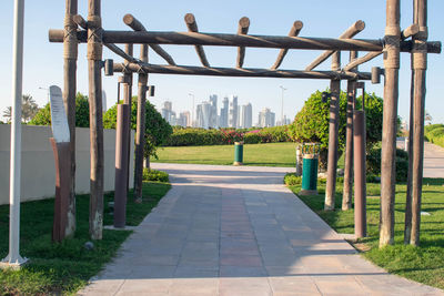 Footpath in park against sky