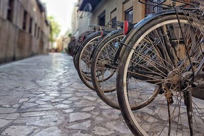 Bicycle parked on cobblestone street