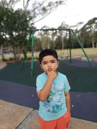 Portrait of happy boy playing in park