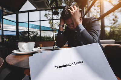 Midsection of man sitting on table