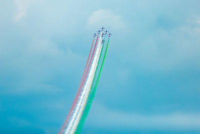 Low angle view of airshow against sky