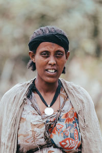 Portrait of smiling young woman standing outdoors