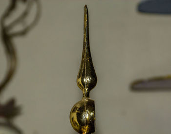 Close-up of decoration on table against wall