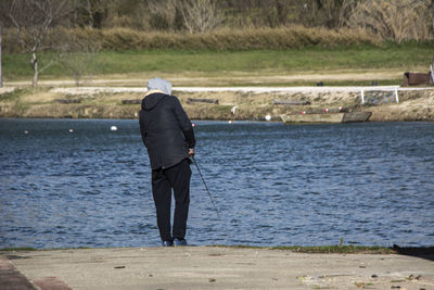 Rear view of man standing at beach