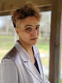 Portrait of young woman standing in gazebo