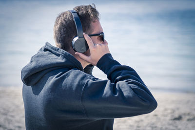 Young man relaxing with headphones listening to music
