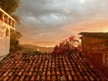 Walkway against sky at sunset