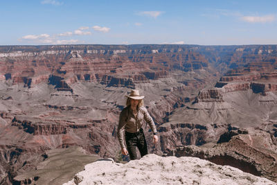 Full length of man on rock against sky