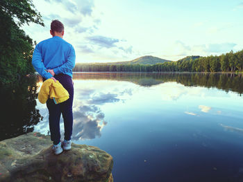 Rear view of man standing in lake