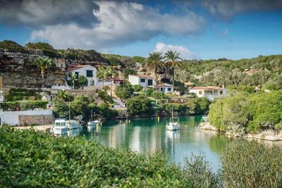 Houses by town against sky