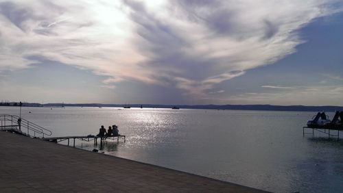 Scenic view of calm sea against cloudy sky