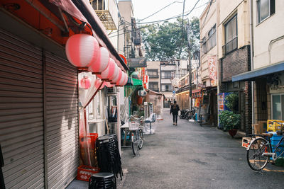 People on street amidst buildings in city