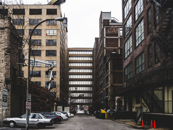 Cars parked by street against buildings