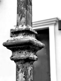 Low angle view of old sculpture against building