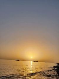 Scenic view of sea against clear sky during sunset