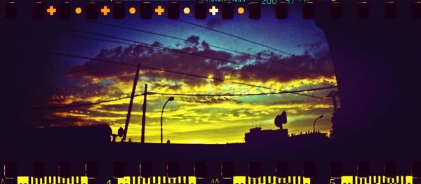 Low angle view of built structure against sky at sunset