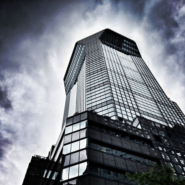 architecture, building exterior, low angle view, built structure, modern, office building, skyscraper, sky, tall - high, city, cloud - sky, glass - material, tower, building, reflection, cloudy, cloud, tall, day, outdoors