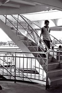 Rear view of man standing on staircase