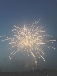 Low angle view of firework display at night