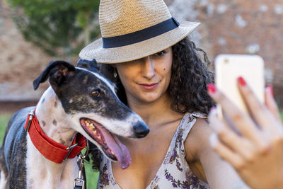 Close-up of woman taking selfie with dog