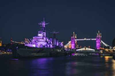 Hms belfast and tower bridge illuminated in purple for queen elizabeth ii