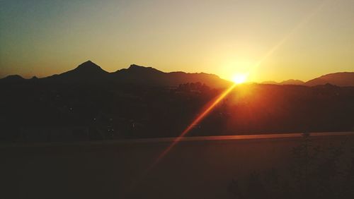 Scenic view of silhouette mountains against sky during sunset