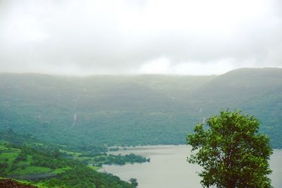 Scenic view of lake against cloudy sky