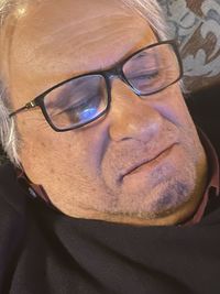 Close-up portrait of man wearing eyeglasses