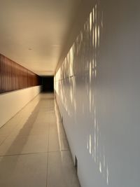 Empty corridor in illuminated building