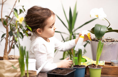 Close-up of girl blowing flowers