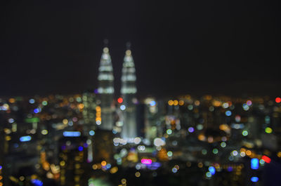 Defocused image of illuminated city at night