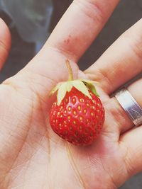 Close-up of cropped hand holding sweet food