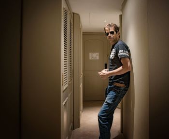 Full length portrait of man standing in corridor