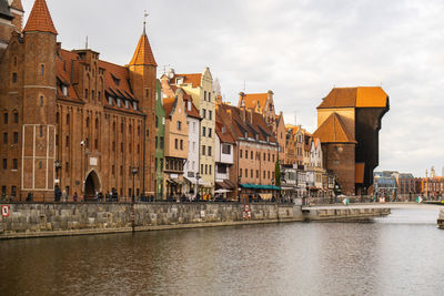 Ancient crane - zuraw old town in gdansk. the riverside on granary island reflection in moltawa